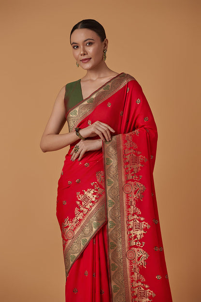 Monjolika Fashion Red Banarasi Silk Blend SareeWith Traditional & Modern Dulha Dulhan Figure Zari Woven Detailing