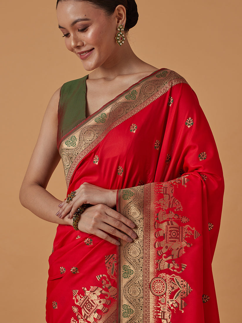 Monjolika Fashion Red Banarasi Silk Blend SareeWith Traditional & Modern Dulha Dulhan Figure Zari Woven Detailing