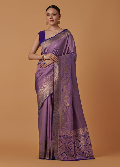 Monjolika Fashion Lavender Banarasi Silk Blend SareeWith Traditional & Modern Dulha Dulhan Figure Zari Woven Detailing