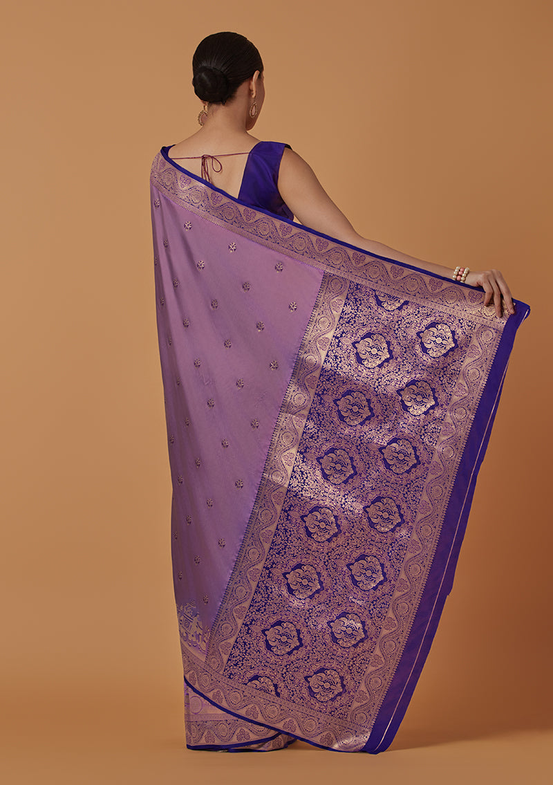 Monjolika Fashion Lavender Banarasi Silk Blend SareeWith Traditional & Modern Dulha Dulhan Figure Zari Woven Detailing