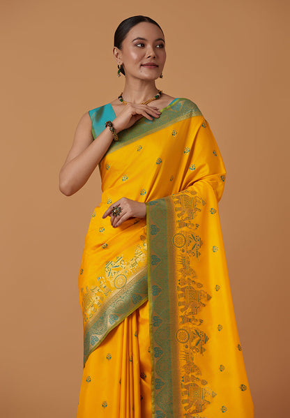 Monjolika Fashion Yellow Banarasi Silk Blend SareeWith Traditional & Modern Dulha Dulhan Figure Zari Woven Detailing
