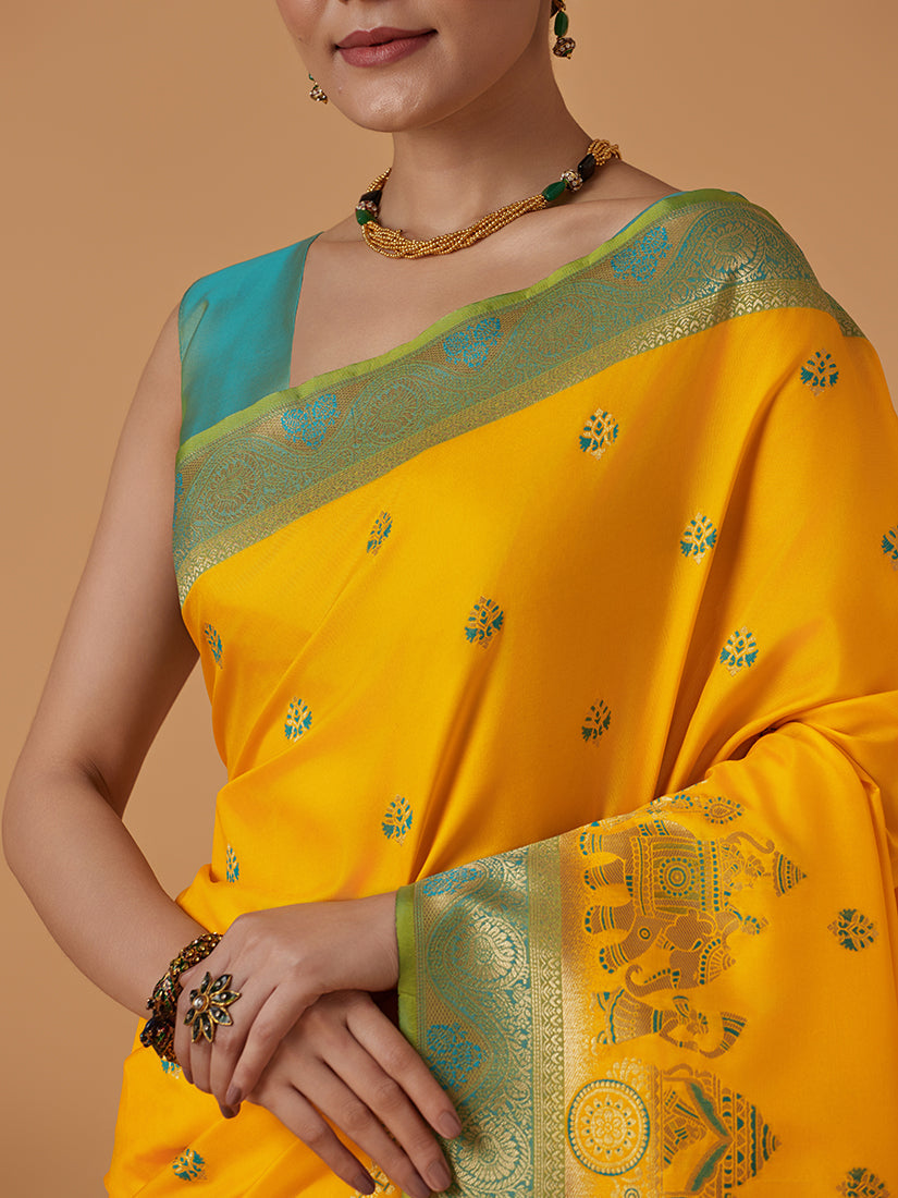 Monjolika Fashion Yellow Banarasi Silk Blend SareeWith Traditional & Modern Dulha Dulhan Figure Zari Woven Detailing