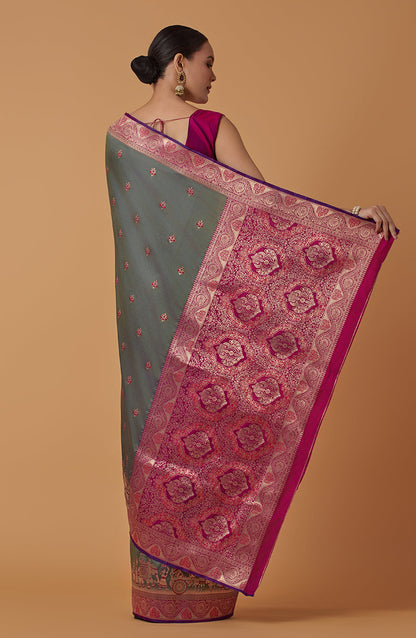 Monjolika Fashion Olive Banarasi Silk Blend SareeWith Traditional & Modern Dulha Dulhan Figure Zari Woven Detailing