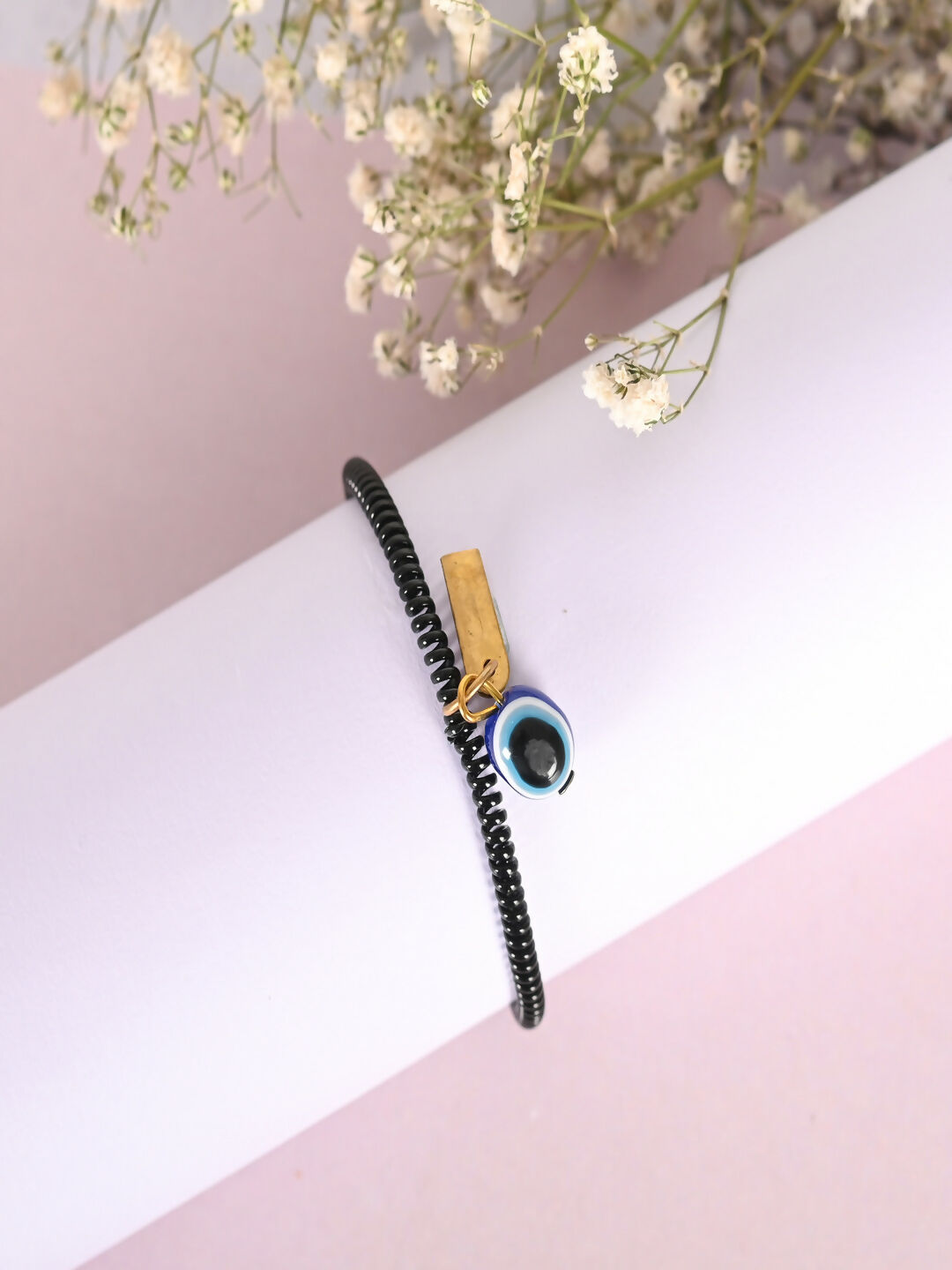 NVR Women & Men Black Evil Eye Spring Ring Rakhi With Roli Chawal