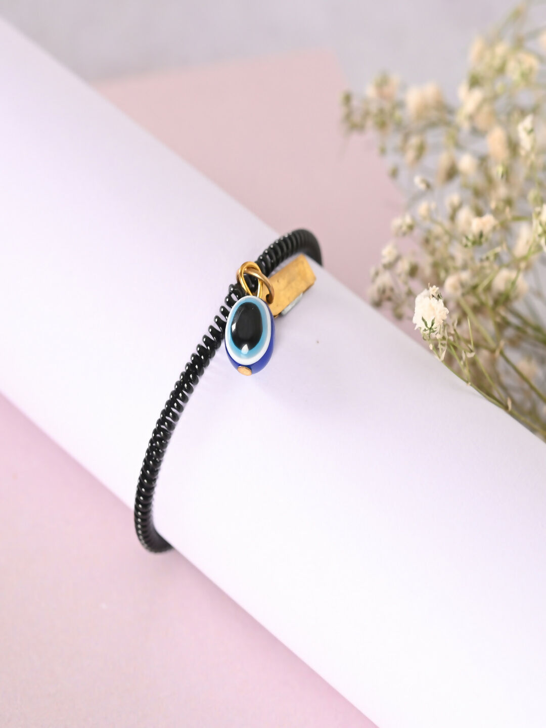 NVR Women & Men Black Evil Eye Spring Ring Rakhi With Roli Chawal