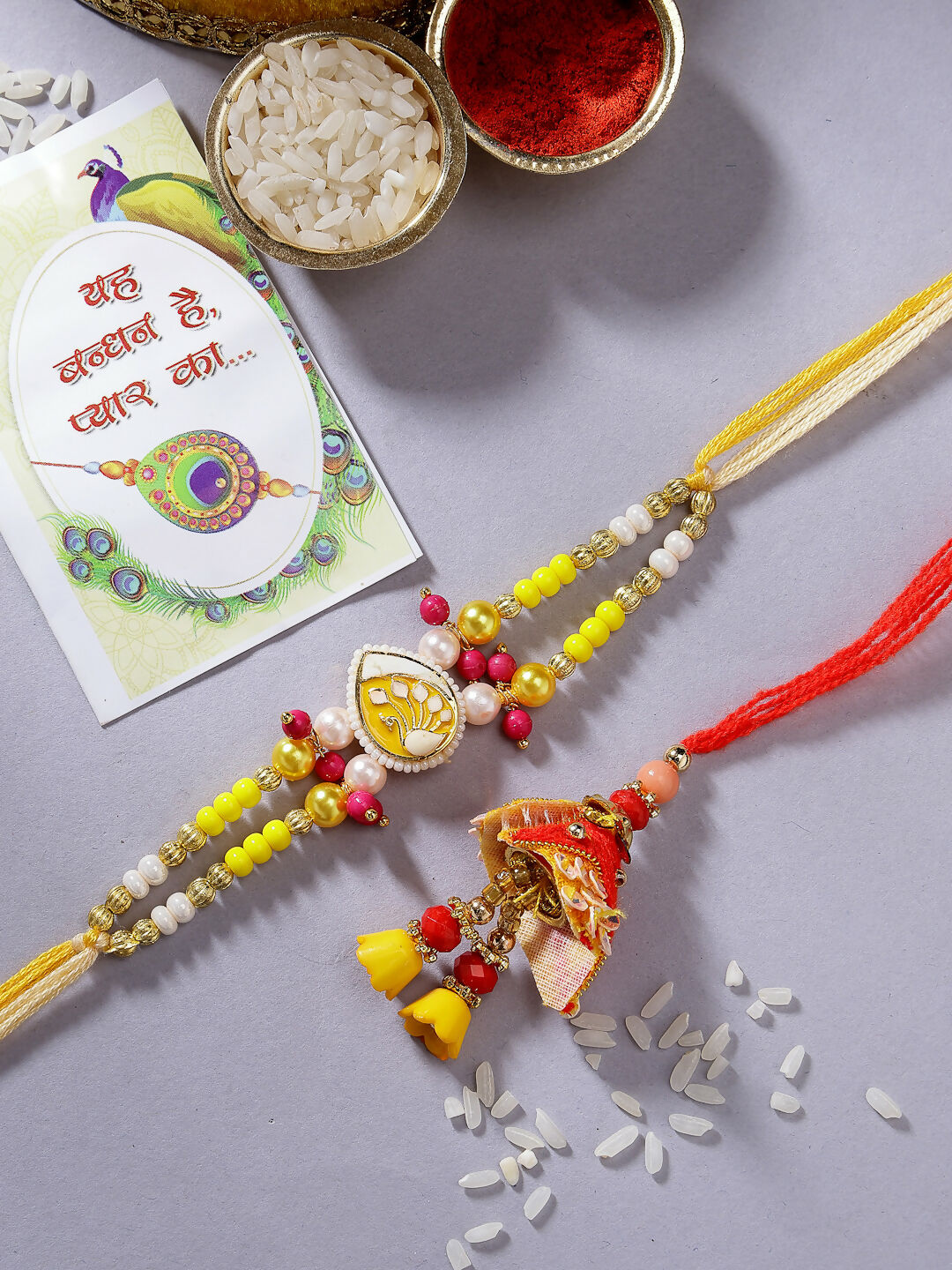 NVR Women & Men Set of 2 Yellow Peacock Design Bhaiya Bhabhi Rakhi With Roli Chawal & Chocolate