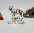 Gold Art India Kamdhenu Cow and Calf Idol with Red Accents Shiny Silver Finish | 7.62 cm