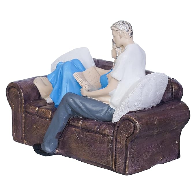 Ecraftindia Romantic Couple Statue Sitting on Sofa and Reading Book Decorative Showpiece
