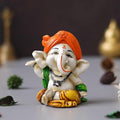 Ecraftindia Orange Polyresin Handcrafted Dancing Lord Ganesha Idol While Sitting | God Idol