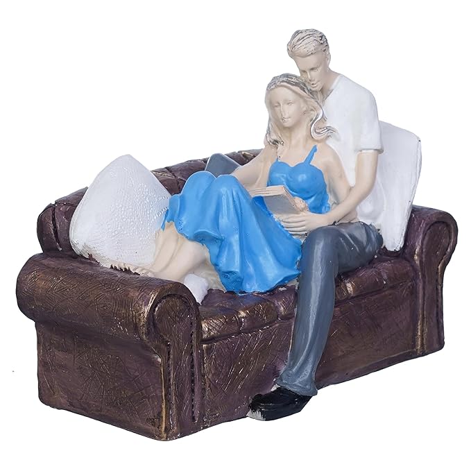 Ecraftindia Romantic Couple Statue Sitting on Sofa and Reading Book Decorative Showpiece