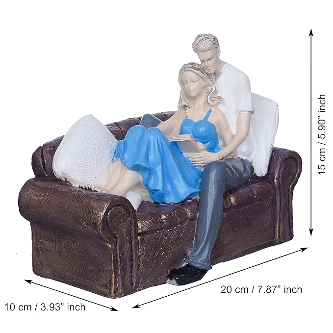 Ecraftindia Romantic Couple Statue Sitting on Sofa and Reading Book Decorative Showpiece