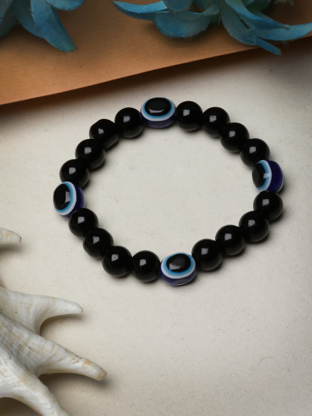 NVR Women & Men Black Evil Eye Elasticated Rakhi With Roli Chawal