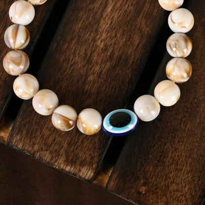 NVR Women & Men Cream-colored Evil Eye Elasticated Rakhi With Roli Chawal