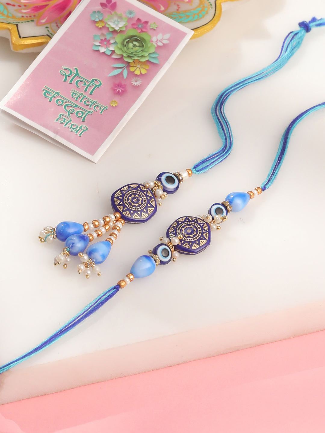 NVR Evil Eye Set of 2 Blue Artificial Beads Bhaiya Bhabhi Rakhi with Roli Chawal Chandan & Mishri