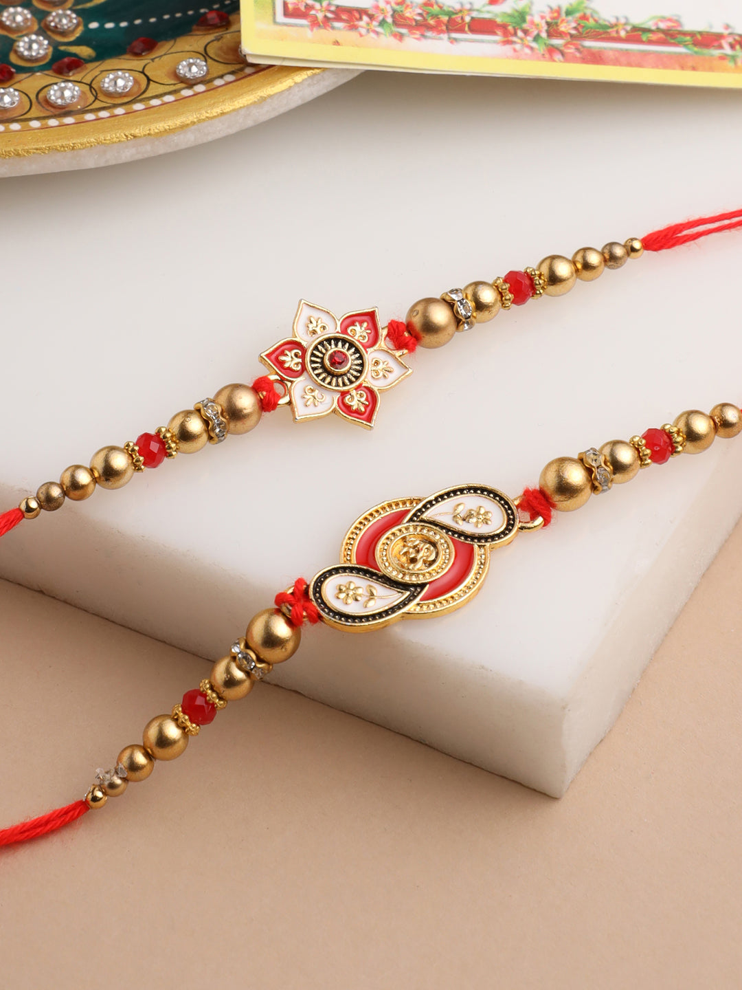 NVR Men Set of 2 Red & Gold Floral Design Artificial Beads Thread Rakhi With Roli Chawal Chandan & Mishri