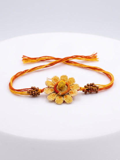 NVR Yellow Floral Seed Thread Rakhi with Roli Chawal Chandan Mishri
