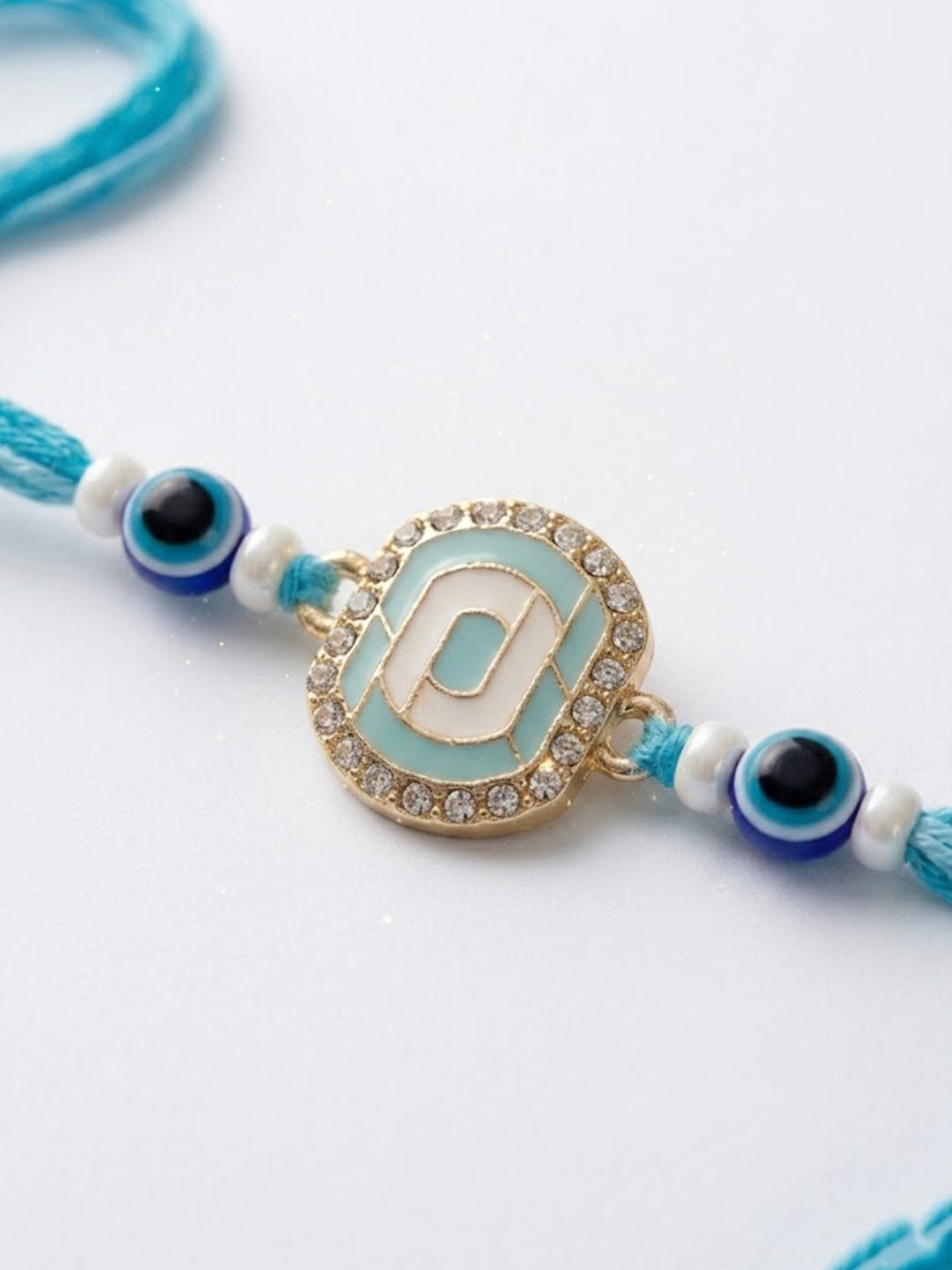 NVR Blue Evil Eye & Artificial Stones Oval Shape Thread Rakhi with Roli Chawal Chandan