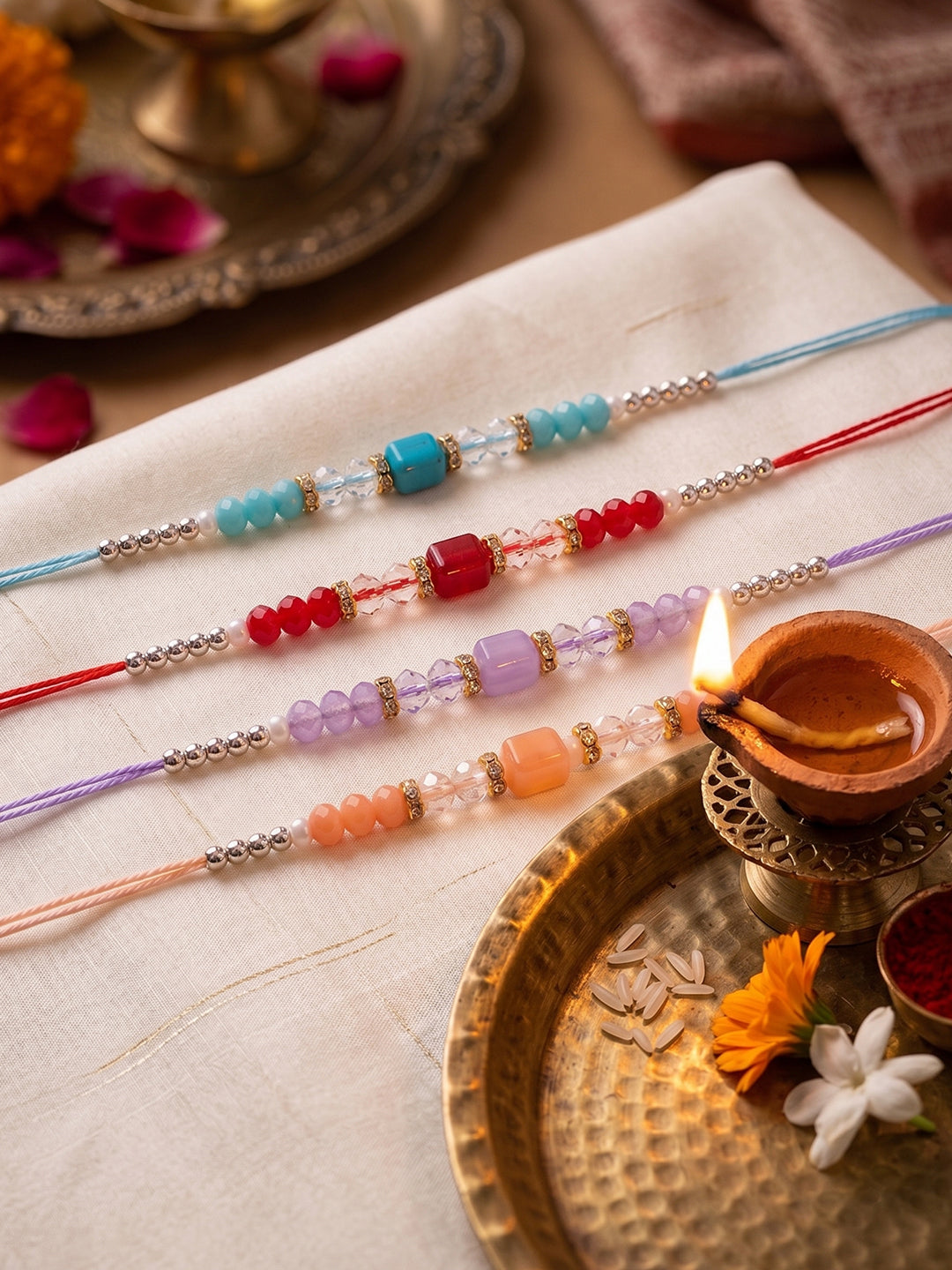 NVR Set of 4 Multicolor Artificial Beads Thread Rakhi with Roli Chawal Chandan Mishri