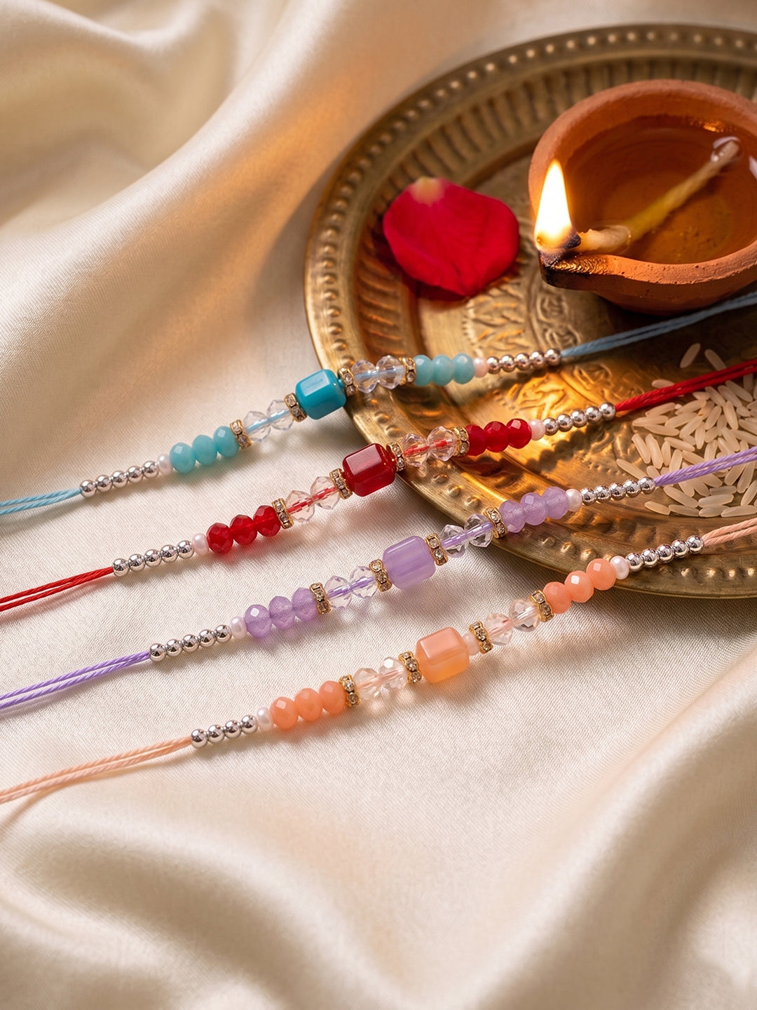 NVR Set of 4 Multicolor Artificial Beads Thread Rakhi with Roli Chawal Chandan Mishri