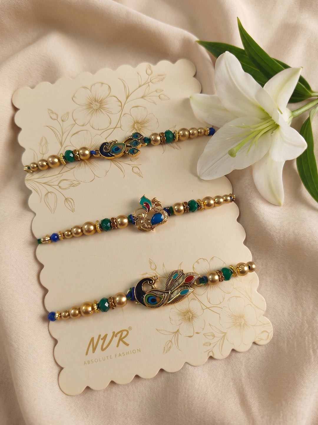 NVR Set of 3 Peacock Design Multicolor Artificial Beads Thread Rakhi With Roli Chawal