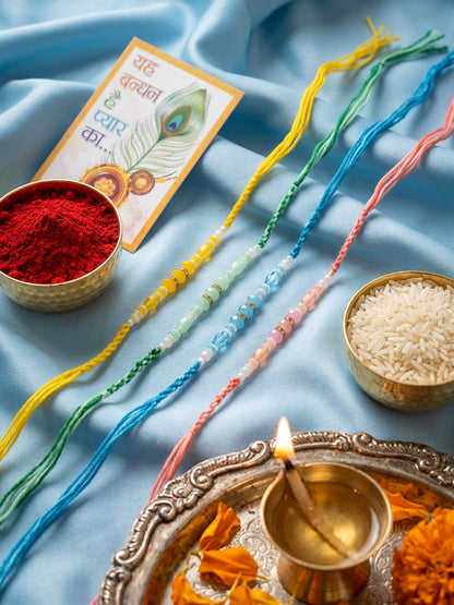 NVR Set of 4 Multicolor Artificial Beads Thread Rakhi with Roli Chawal Chandan Mishri