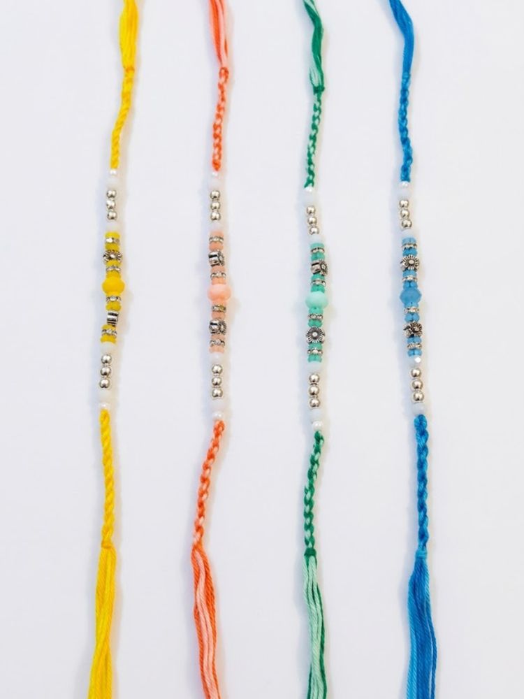 NVR Set of 4 Multicolor Artificial Beads Thread Rakhi with Roli Chawal Chandan Mishri