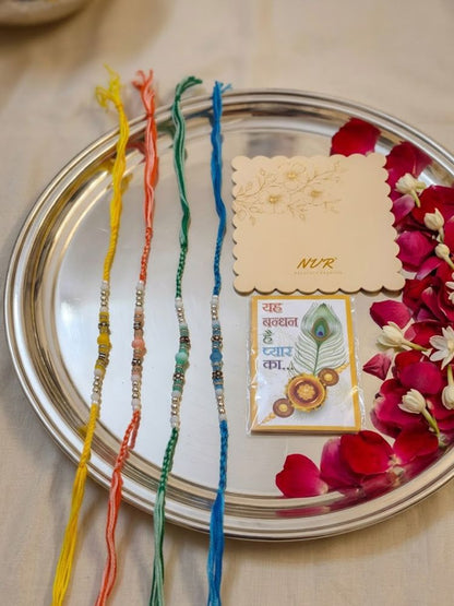 NVR Set of 4 Multicolor Artificial Beads Thread Rakhi with Roli Chawal Chandan Mishri