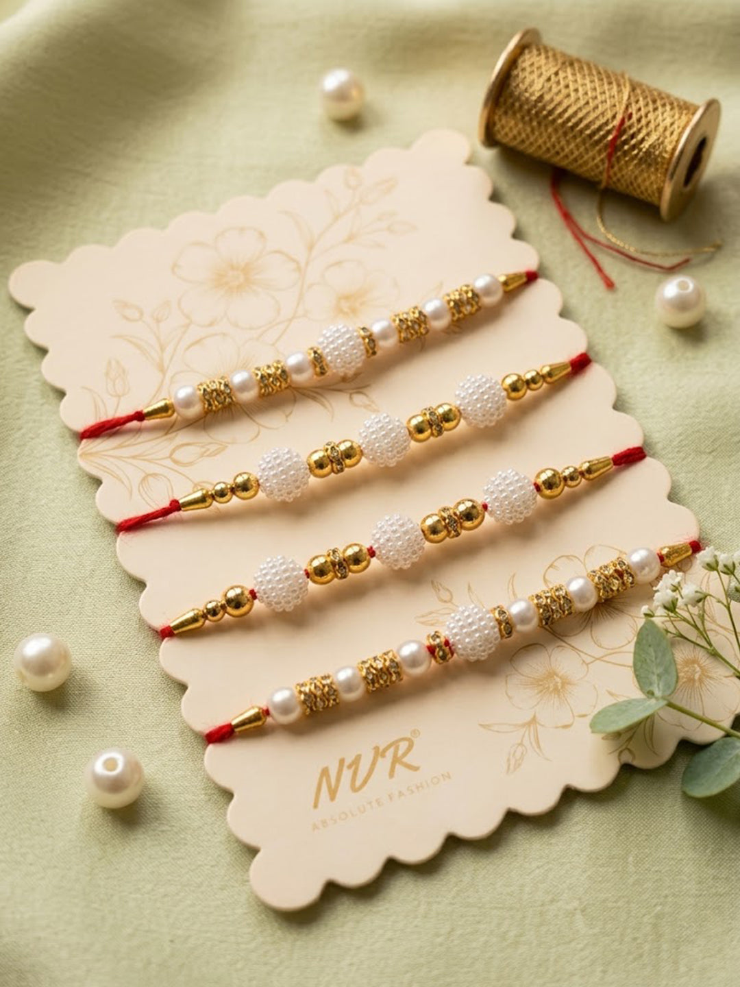 NVR Set of 4 White Pearls & Red Thread Rakhi With Roli Chawal Chandan Mishri