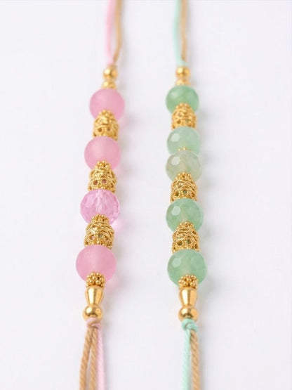 NVR Set of 2 Pink & Green Artificial Beads Thread Rakhi With Roli Chawal Chandan Mishri