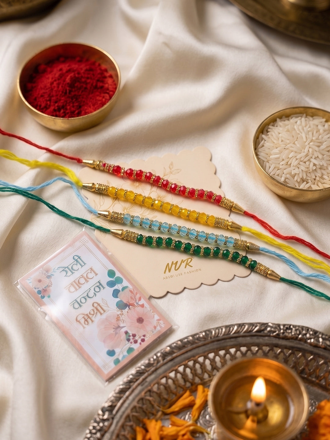 NVR Set of 4 Multicolor Artificial Beads Thread Rakhi with Roli Chawal Chandan Mishri