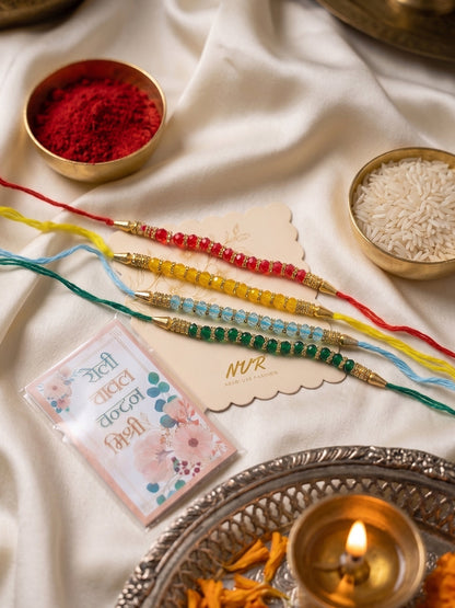NVR Set of 4 Multicolor Artificial Beads Thread Rakhi with Roli Chawal Chandan Mishri