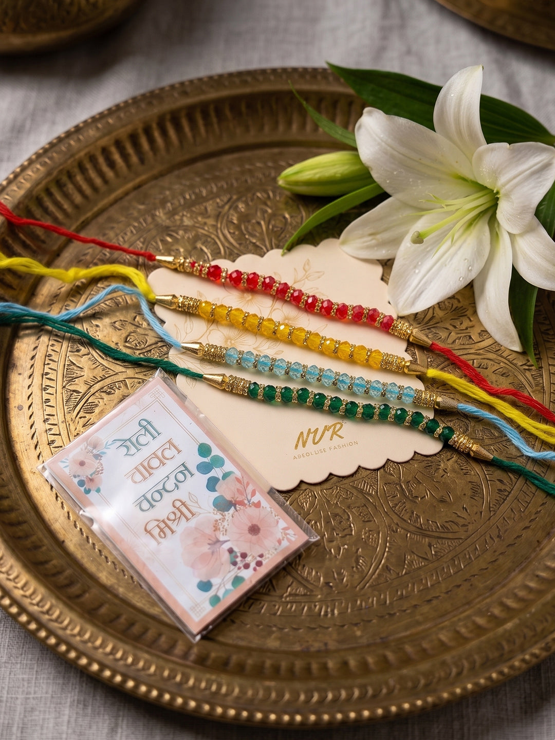 NVR Set of 4 Multicolor Artificial Beads Thread Rakhi with Roli Chawal Chandan Mishri