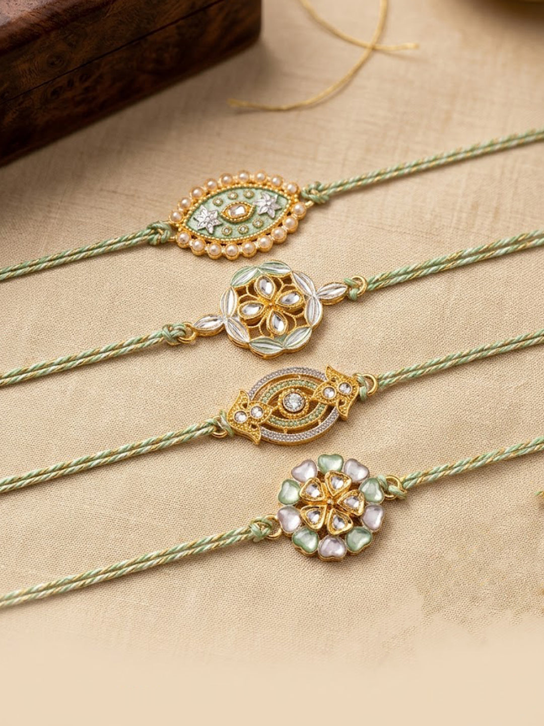 NVR Set of 4 White Artificial Stones & Green Thread Rakhi with Roli Chawal Chandan Mishri