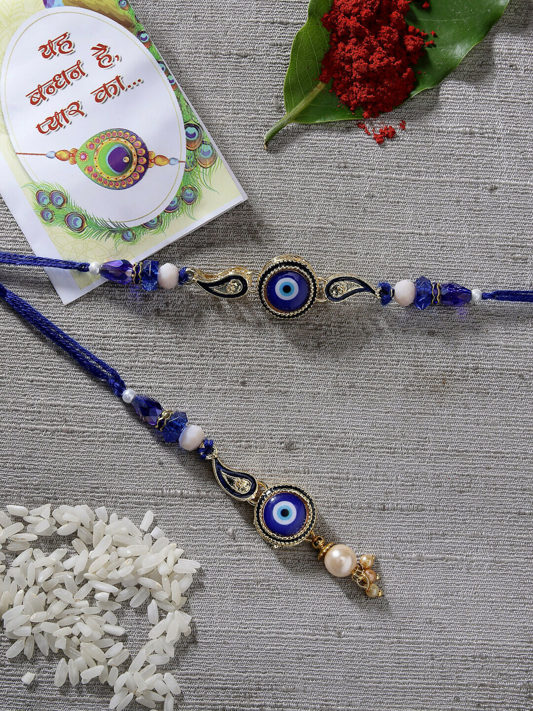 NVR Women & Men Set of 2 Blue Evil Eye Beaded Bhaiya Bhabhi Rakhi With Roli Chawal & Chocolate