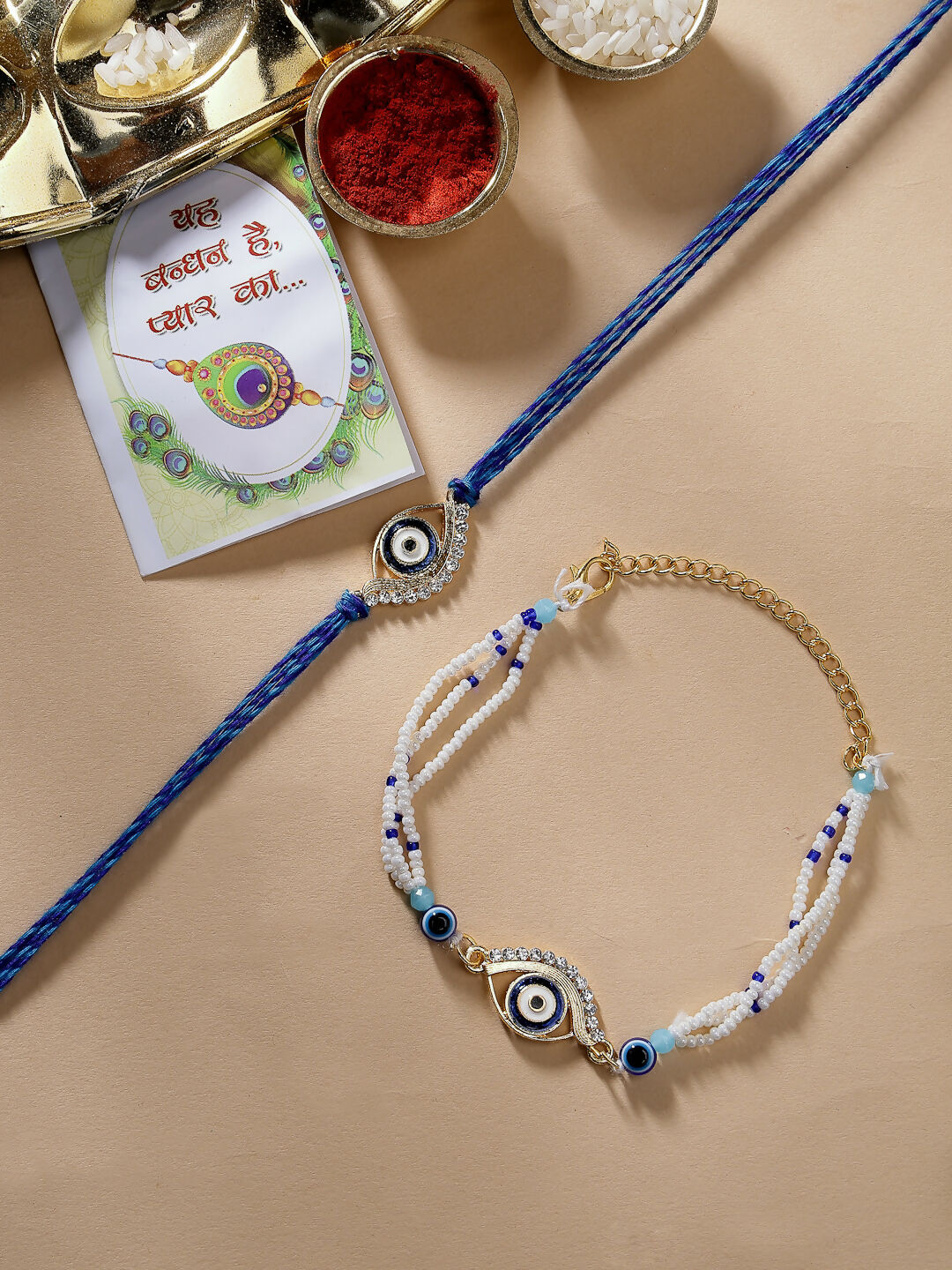 NVR Women & Men Set of 2 Blue Evil Eye Bhaiya Bhabhi Rakhi Set With Roli Chawal & Chocolate