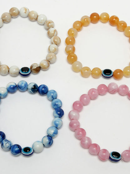 NVR Women & Men Set of 4 Multicolor Evil Eye Elasticated Rakhi With Roli Chawal