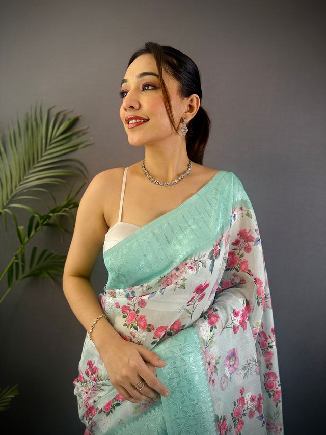 Elora Cyan Blue Silk Floral Motifs Coppery Tone Contrast Floral Border Banarasi Saree
