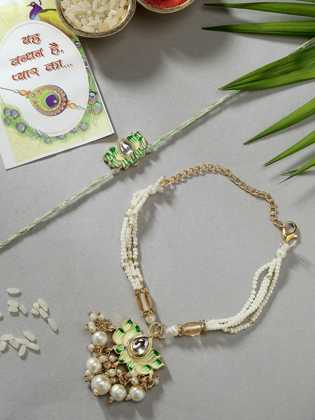 NVR Women & Men Set of 2 Green Lotus Shape Kundan-Studded & Beaded Wraparound Rakhi Set With Roli Chawal & Chocolate